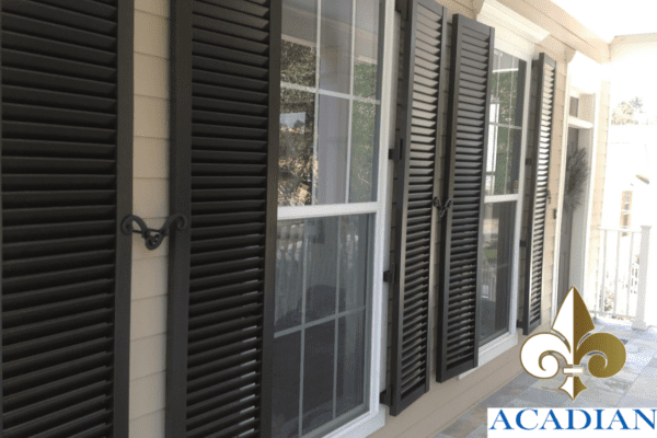 A local home featuring hurricane shutters for vinyl siding installed by Acadian Windows
