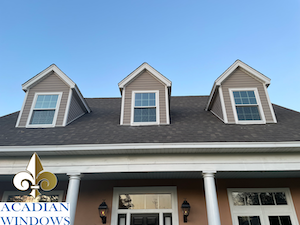 Our Vinyl Windows Spanish Fort Company represented by a photo a home with multiple window types with the Acadian Windows logo.