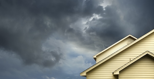 Are Impact Windows Energy Efficient? represented by an image of a stormy sky above a home.
