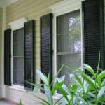 the hurricane shutters Kenner can trust represented by colonial shutters on a home