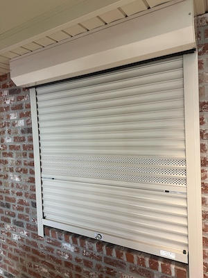 A customer home displaying our roll down hurricane shutters near you