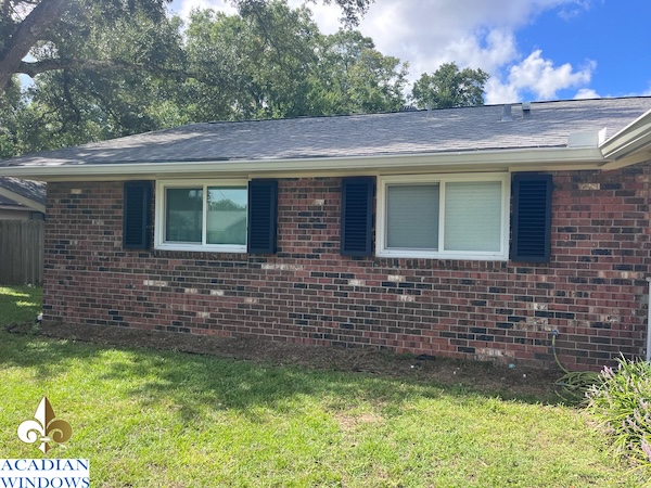 An example of the hurricane shutters Destrehan homeowners have had installed by Acadian Windows, black colonial shutters on a local brick house